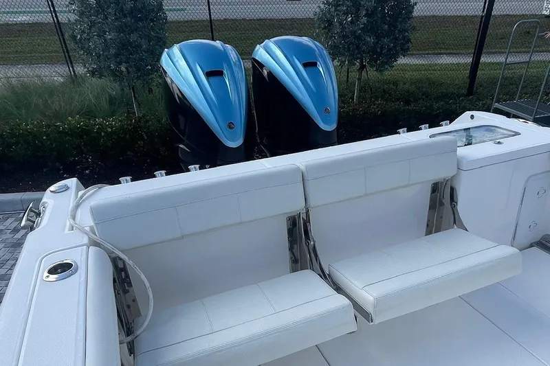  Yacht Photos Pics 2022 Everglades 335 Center Console boat with dual blue outboard engines and white seating.