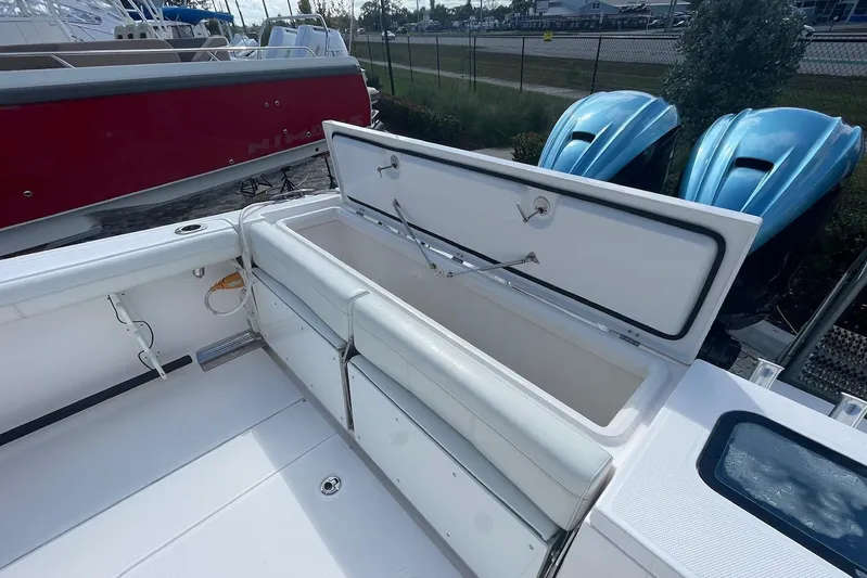  Yacht Photos Pics 2022 Everglades 335 Center Console boat with open storage compartment and twin blue engines.