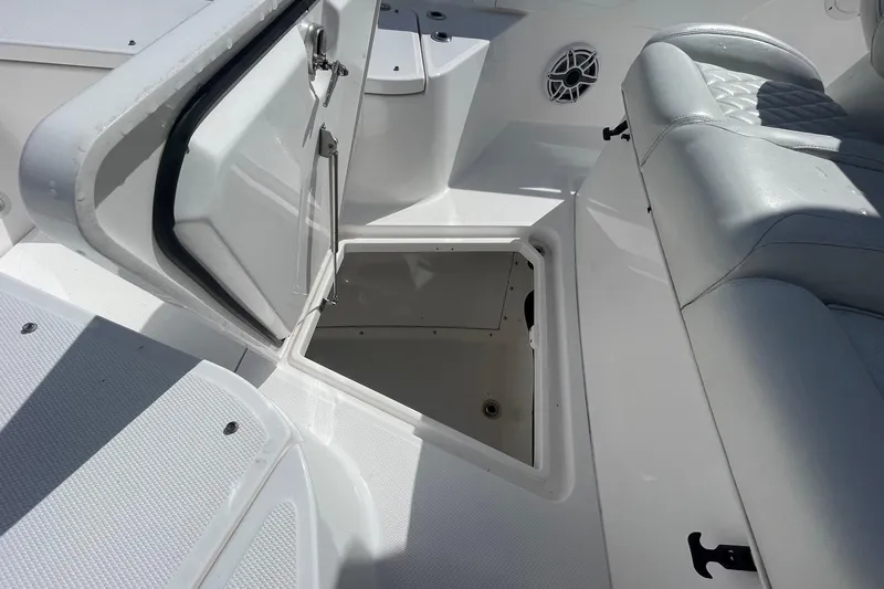  Yacht Photos Pics 2022 Everglades 335 Center Console boat with open storage compartment and cushioned seating.