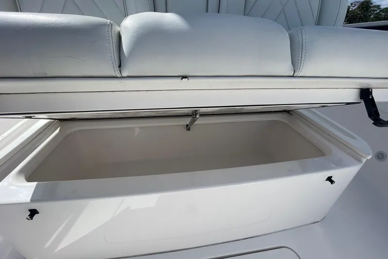  Yacht Photos Pics 2022 Everglades 335 Center Console storage compartment with cushioned seating.