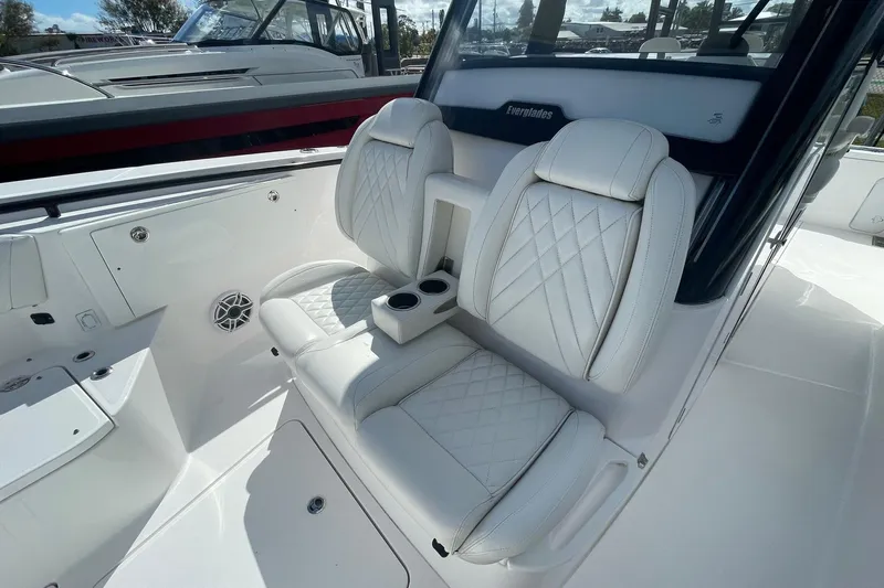  Yacht Photos Pics 2022 Everglades 335 Center Console boat interior with white leather seating and cup holders.