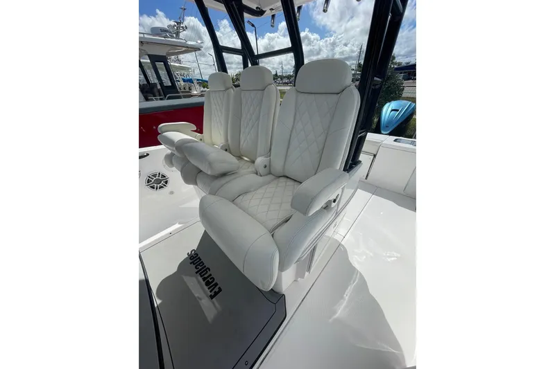  Yacht Photos Pics Luxurious seating on 2022 Everglades 335 Center Console boat, featuring white quilted upholstery.