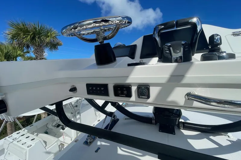  Yacht Photos Pics 2022 Everglades 335 Center Console helm with controls, steering wheel, and clear blue sky.