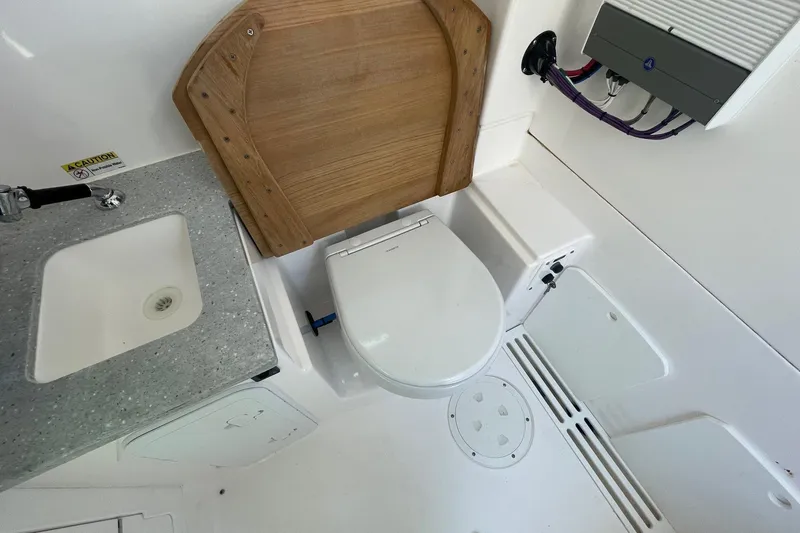  Yacht Photos Pics 2022 Everglades 335 Center Console boat bathroom with sink and toilet.