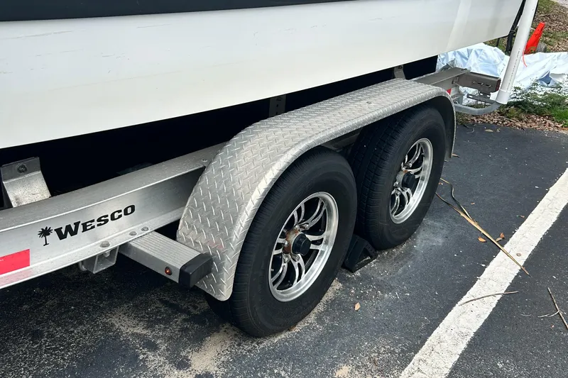  Yacht Photos Pics Trailer with dual wheels for 2024 Cobalt R6 boat, parked on asphalt.