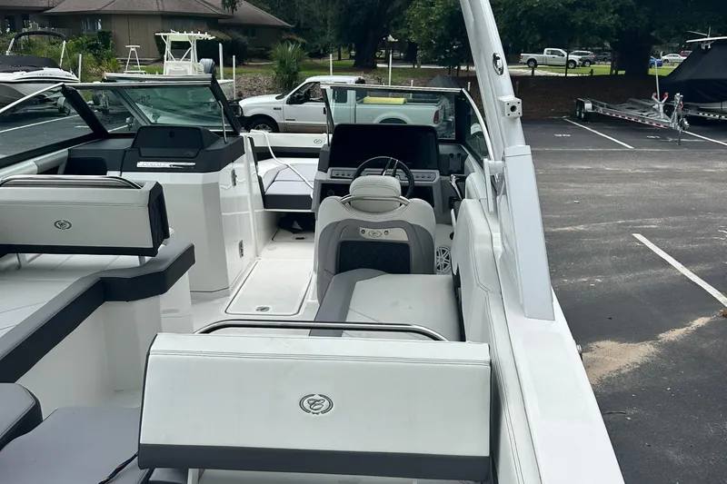  Yacht Photos Pics 2024 Cobalt R6 boat interior with sleek seating and modern dashboard in a parking lot.