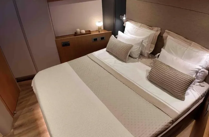  Yacht Photos Pics Luxurious bedroom interior on Inace AVENTURA 106 yacht, 2027 model, featuring elegant bedding and ambient lighting.