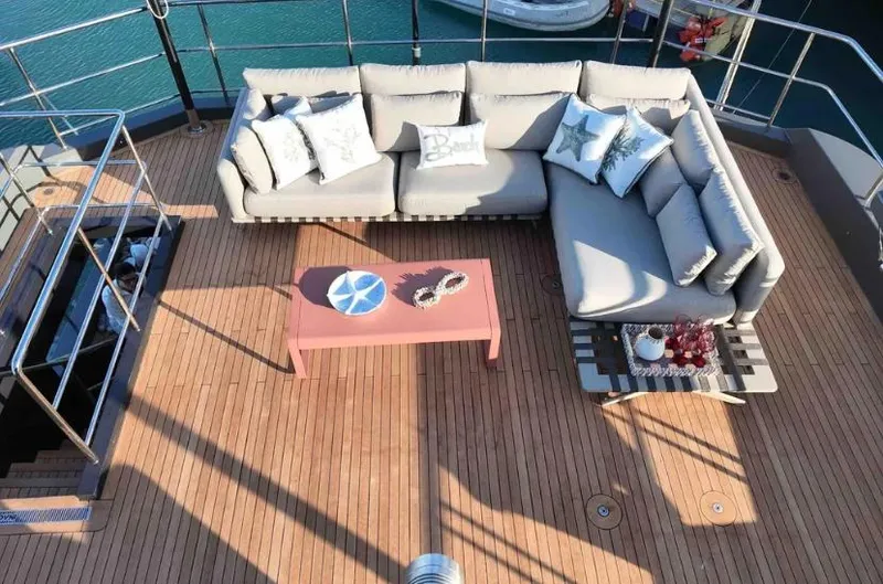  Yacht Photos Pics Luxurious deck seating on 2027 Inace AVENTURA 106 yacht with stylish cushions and table.
