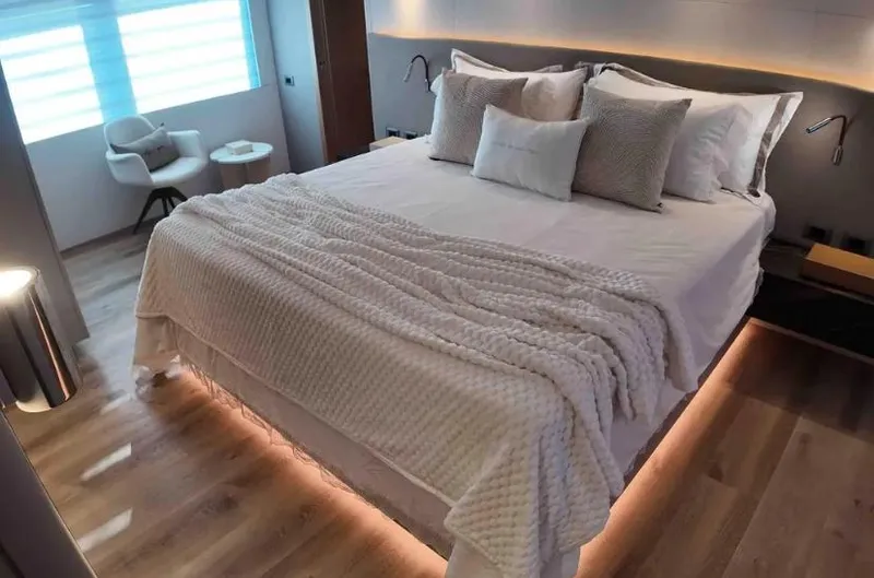  Yacht Photos Pics Luxurious bedroom in 2027 Inace AVENTURA 106 yacht with modern decor and ambient lighting.
