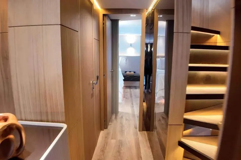  Yacht Photos Pics Luxurious interior of 2027 Inace AVENTURA 106 yacht with modern wood finishes and elegant lighting.