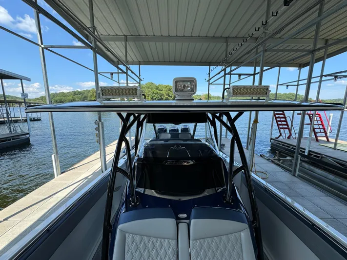  Yacht Photos Pics 2019 Nor-Tech 390 Sport Center Console docked under a covered marina.