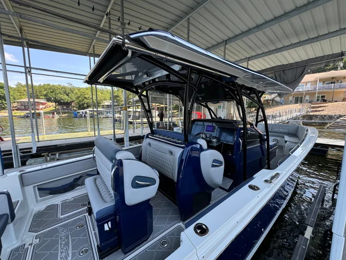  Yacht Photos Pics 2019 Nor-Tech 390 Sport Center Console boat docked under a covered marina.