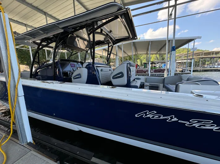  Yacht Photos Pics 2019 Nor-Tech 390 Sport Center Console boat docked under a covered marina.