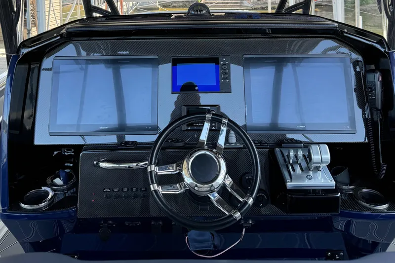  Yacht Photos Pics 2019 Nor-Tech 390 Sport Center Console dashboard with dual Garmin screens and steering wheel.