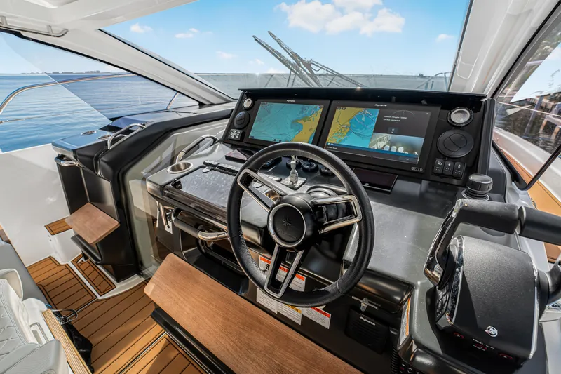 Equanimity Yacht Photos Pics 2023 Jeanneau DB43 helm with dual navigation screens and modern steering wheel.