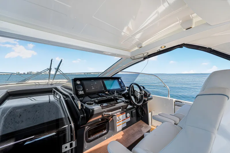 Equanimity Yacht Photos Pics 2023 Jeanneau DB43 yacht cockpit with modern controls, overlooking serene ocean view.