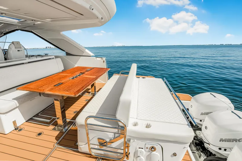 Equanimity Yacht Photos Pics 2023 Jeanneau DB43 yacht deck with seating, table, and ocean view.