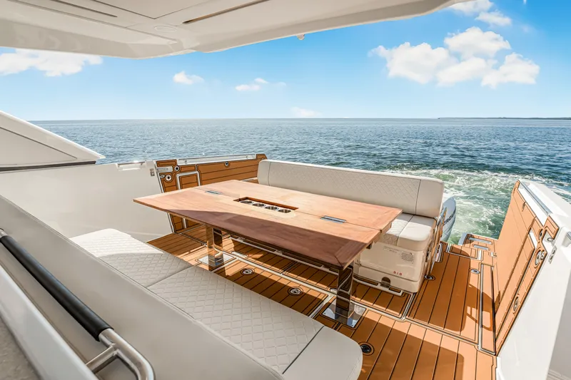 Equanimity Yacht Photos Pics Luxurious Jeanneau DB43 yacht deck with seating and table, overlooking the ocean, 2023 model.