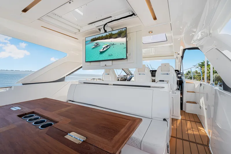 Equanimity Yacht Photos Pics Luxurious interior of 2023 Jeanneau DB43 yacht with sleek seating and a mounted TV.