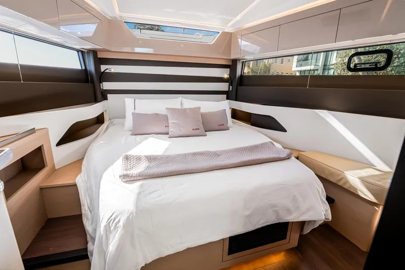Equanimity Yacht Photos Pics Luxurious cabin interior of 2023 Jeanneau DB43 yacht with elegant bedding and modern design.