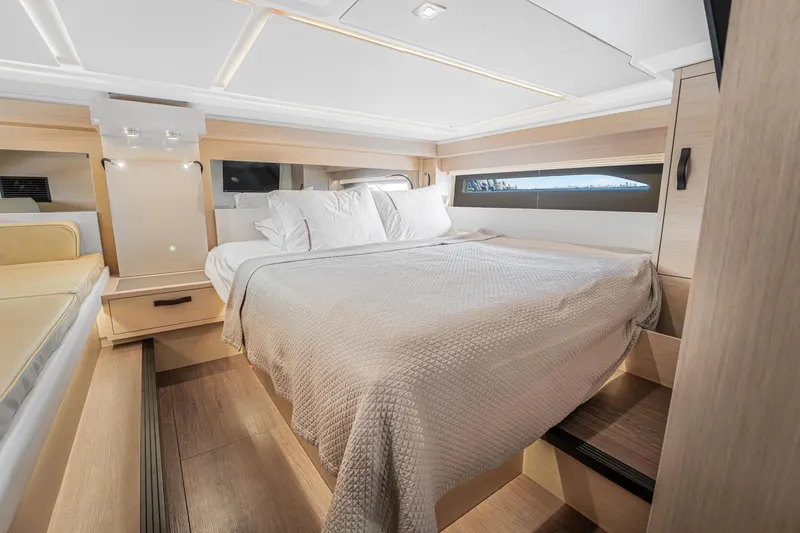 Equanimity Yacht Photos Pics Luxurious cabin interior of 2023 Jeanneau DB43 yacht with cozy bed and modern design.