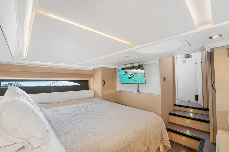 Equanimity Yacht Photos Pics Luxurious cabin interior of 2023 Jeanneau DB43 yacht with bed and TV.