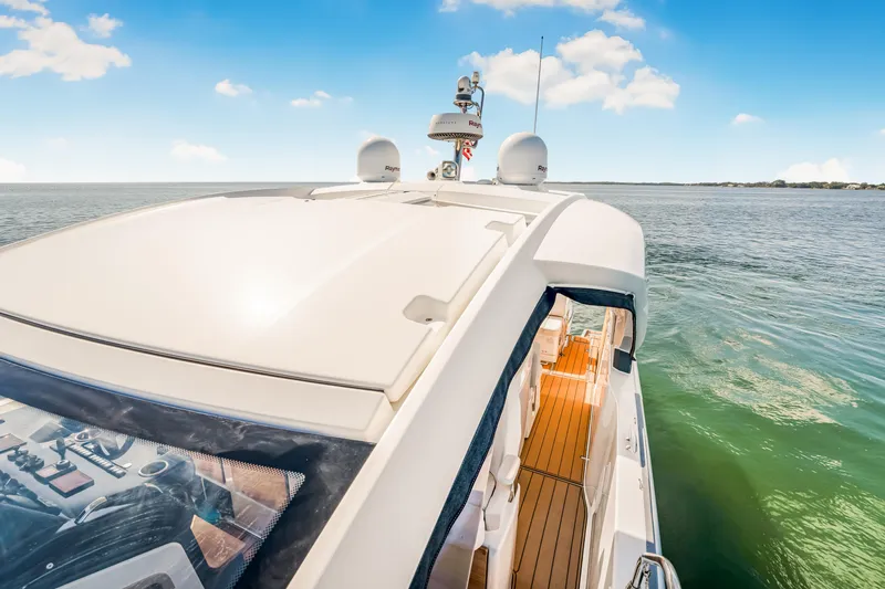 Equanimity Yacht Photos Pics 2023 Jeanneau DB43 yacht on calm water under a clear blue sky.