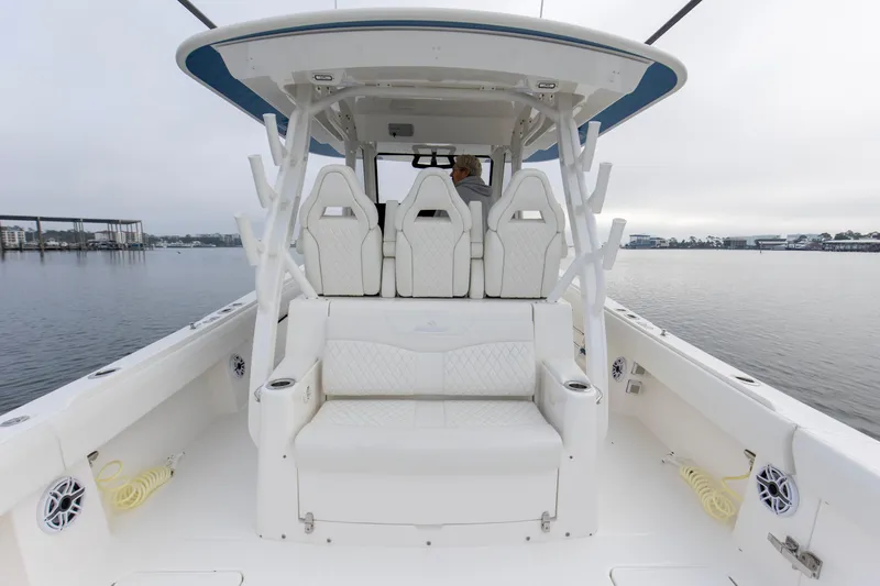  Yacht Photos Pics 2024 Regulator 37 boat interior with white seating and helm, on calm water.