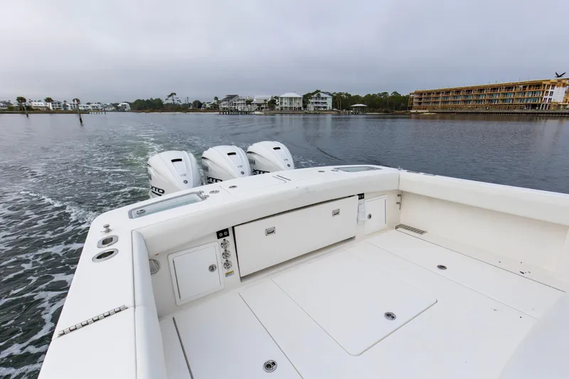  Yacht Photos Pics 2024 Regulator 37 boat with triple outboard engines on calm water.