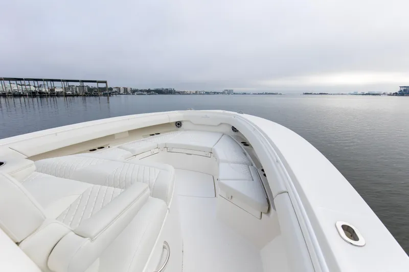  Yacht Photos Pics 2024 Regulator 37 boat with white seating, docked on calm water.
