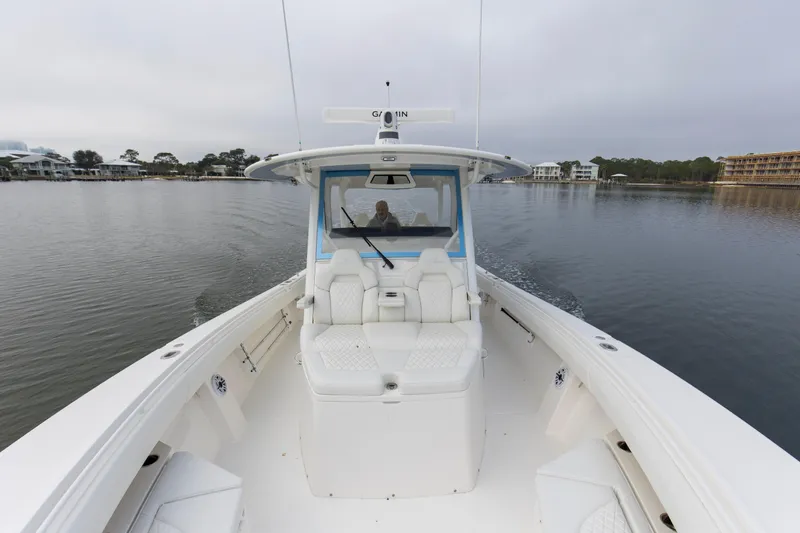  Yacht Photos Pics 2024 Regulator 37 boat cruising on calm waters, showcasing spacious deck and seating.