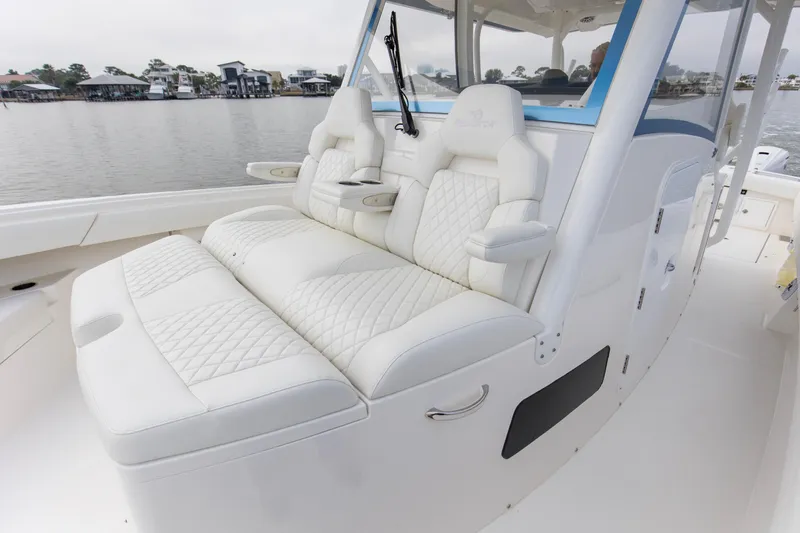  Yacht Photos Pics Luxurious seating on 2024 Regulator 37 boat, featuring white quilted upholstery.