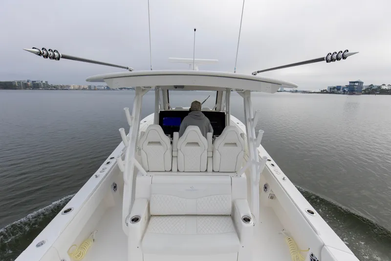  Yacht Photos Pics 2024 Regulator 37 boat cruising on calm waters, showcasing spacious deck and modern design.