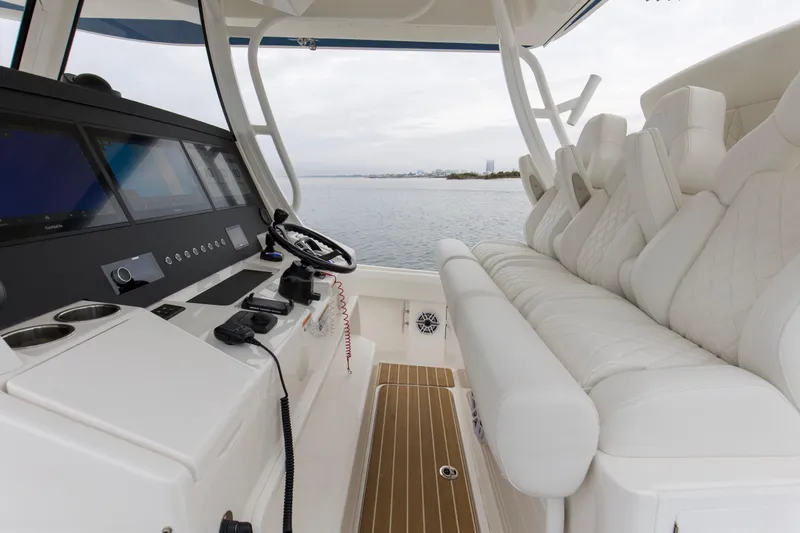  Yacht Photos Pics 2024 Regulator 37 boat interior with luxurious seating and advanced control panel.