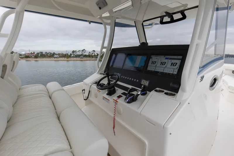  Yacht Photos Pics 2024 Regulator 37 boat cockpit with modern navigation system and luxurious seating.