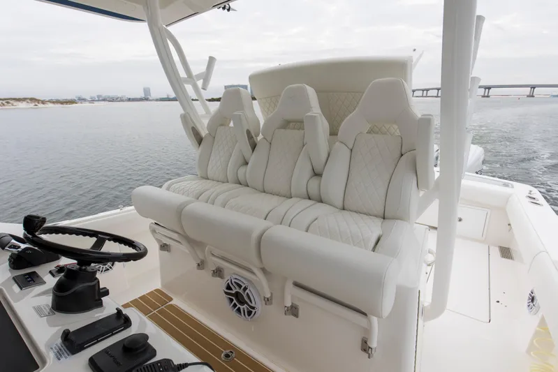 Yacht Photos Pics 2024 Regulator 37 boat interior with luxurious white seating and modern helm controls.
