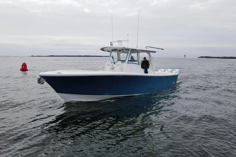  Yacht Photos Pics 2024 Regulator 37 boat on open water, featuring a sleek blue hull design.