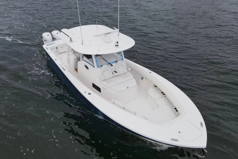  Yacht Photos Pics 2024 Regulator 37 boat cruising on open water, showcasing sleek design and powerful engines.