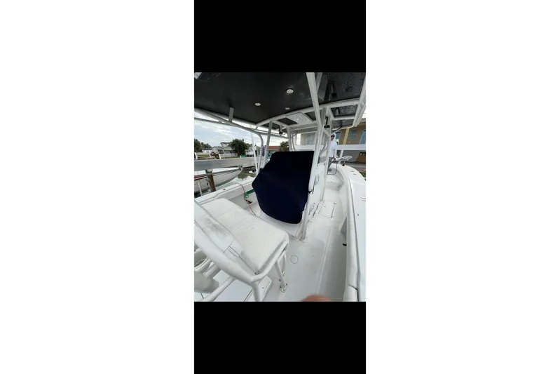  Yacht Photos Pics 2003 Jupiter 31 boat interior with white seating and blue cover.