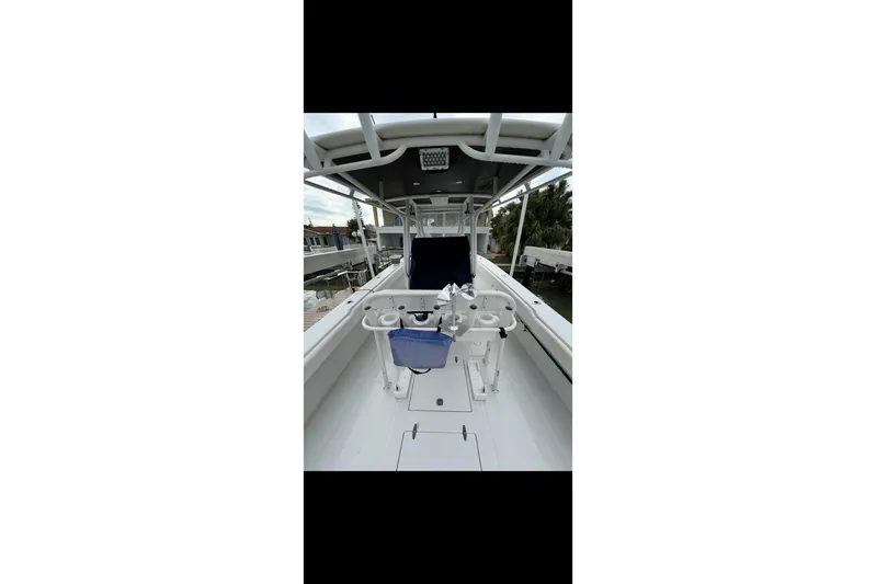  Yacht Photos Pics 2003 Jupiter 31 boat interior with fishing rod holders and seating.