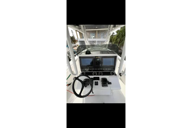  Yacht Photos Pics 2003 Jupiter 31 boat dashboard with steering wheel and navigation screens.