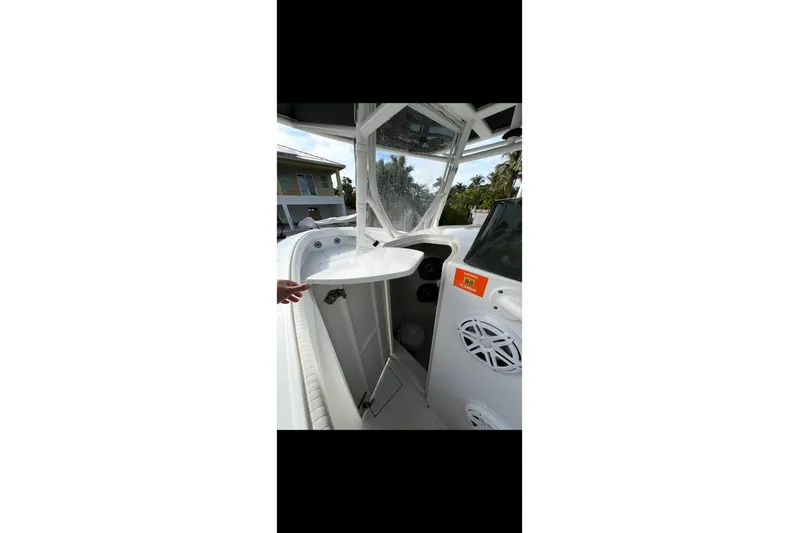  Yacht Photos Pics 2003 Jupiter 31 boat interior with open storage compartment and visible speakers.