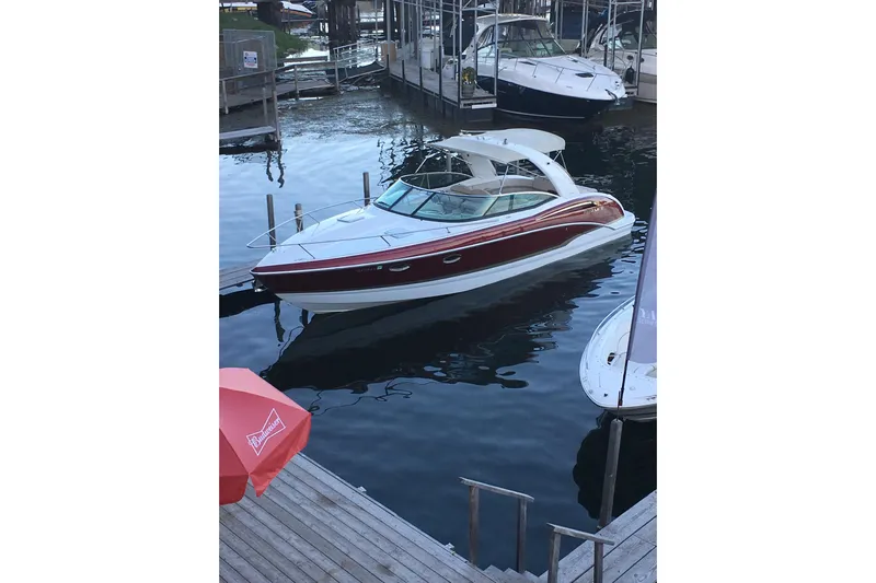  Yacht Photos Pics 2012 Formula 310 Sun Sport boat docked in a marina, featuring sleek design and red accents.