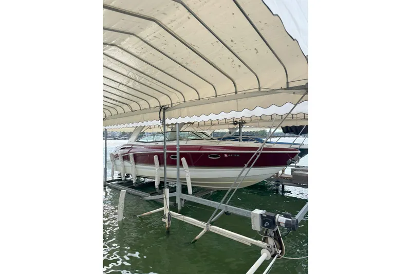  Yacht Photos Pics 2012 Formula 310 Sun Sport boat docked under canopy on water.