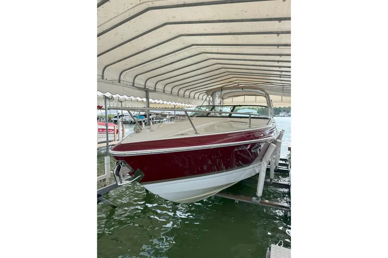  Yacht Photos Pics 2012 Formula 310 Sun Sport boat docked under a canopy.
