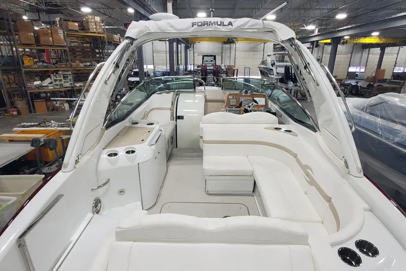  Yacht Photos Pics 2012 Formula 310 Sun Sport boat interior in a warehouse setting.