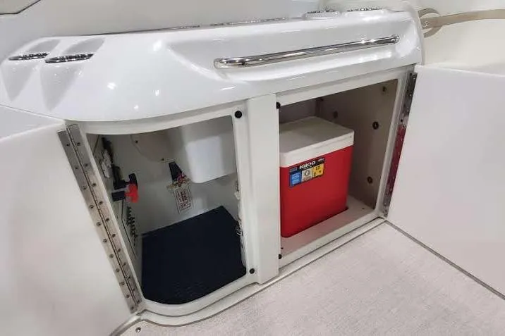  Yacht Photos Pics Storage compartment on a 2012 Formula 310 Sun Sport boat with a red cooler.
