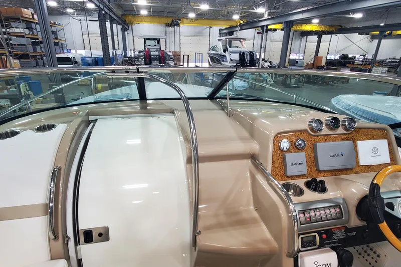  Yacht Photos Pics 2012 Formula 310 Sun Sport boat dashboard with Garmin navigation in a warehouse setting.