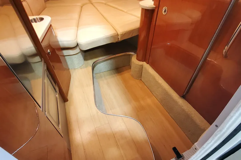  Yacht Photos Pics Interior of 2012 Formula 310 Sun Sport boat with beige seating and wooden flooring.