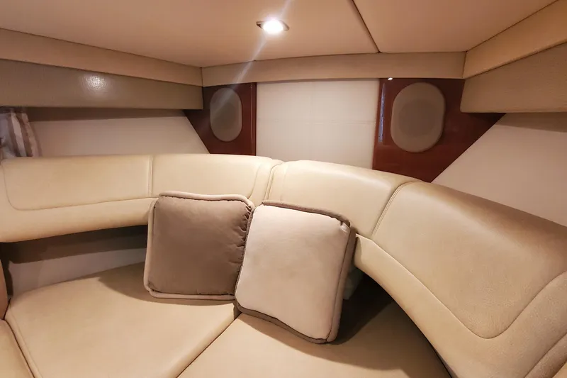  Yacht Photos Pics Luxurious interior of 2012 Formula 310 Sun Sport boat with beige seating and cushions.